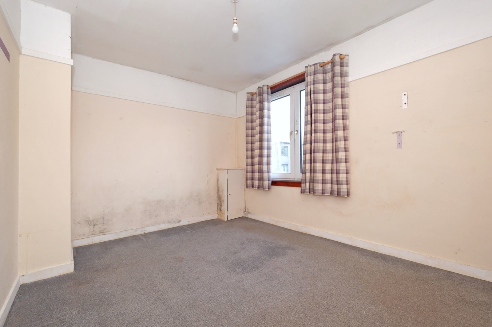 Damp-affected bedroom before refurbishment